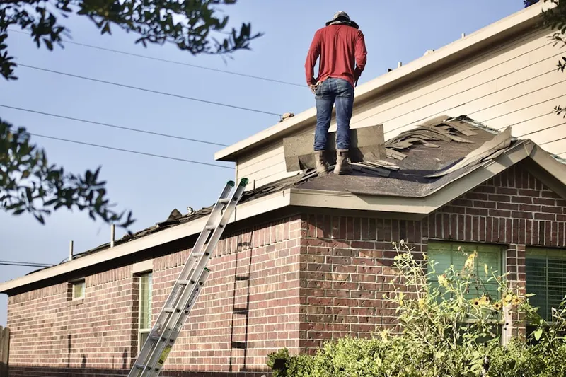 Professional roofer working on a residential roof in Tree of Knowledge Corner